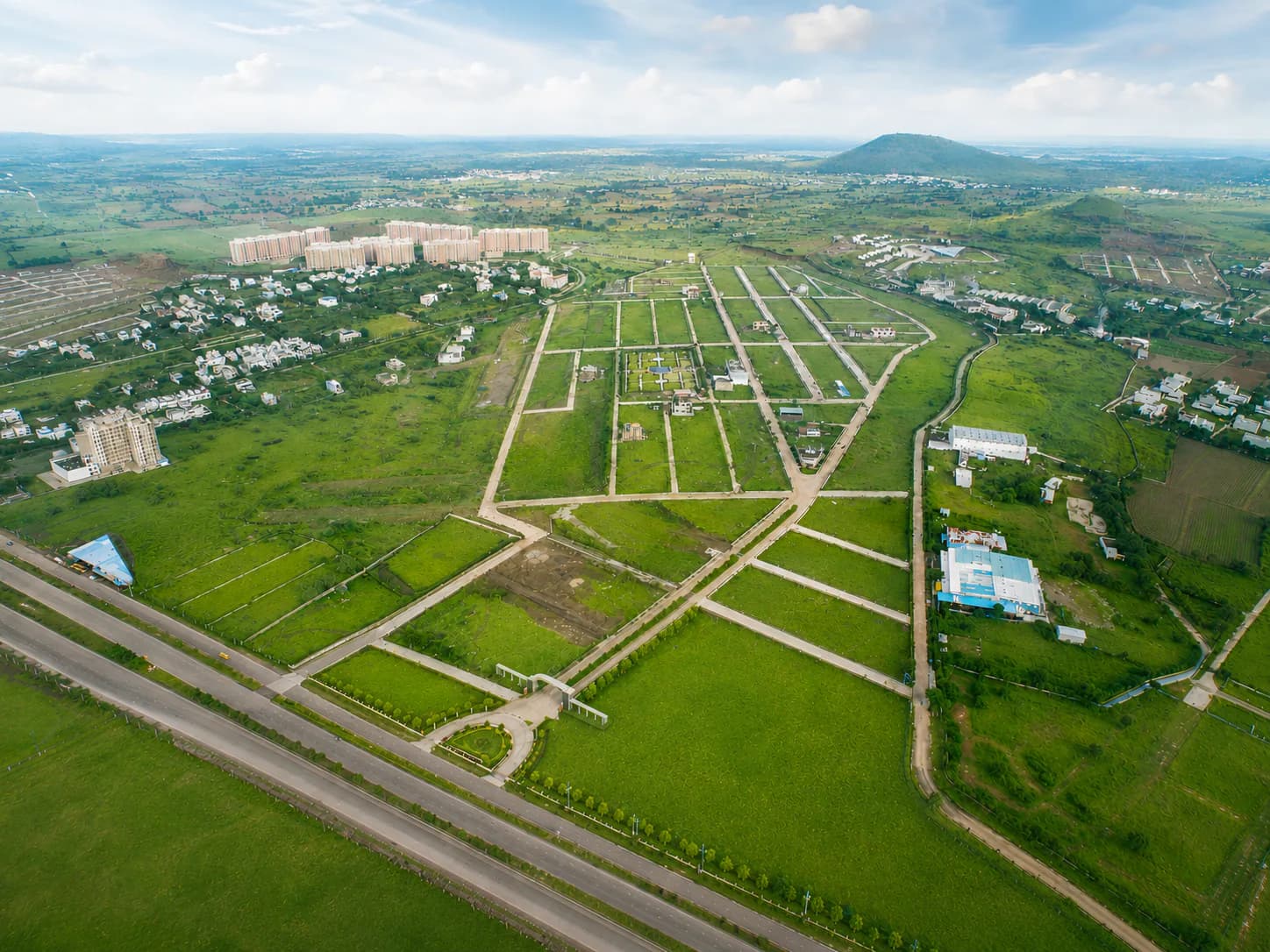 Chinar Hills township road and landscaped surroundings