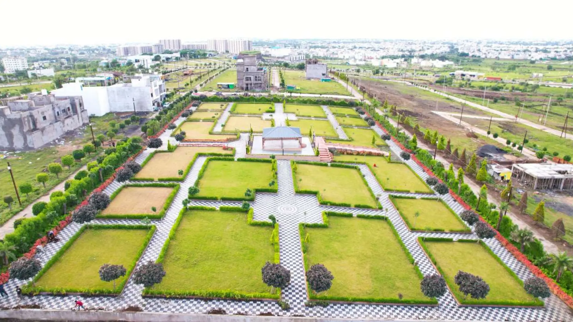 Aerial view of a landscaped garden with geometric lawns and paved paths