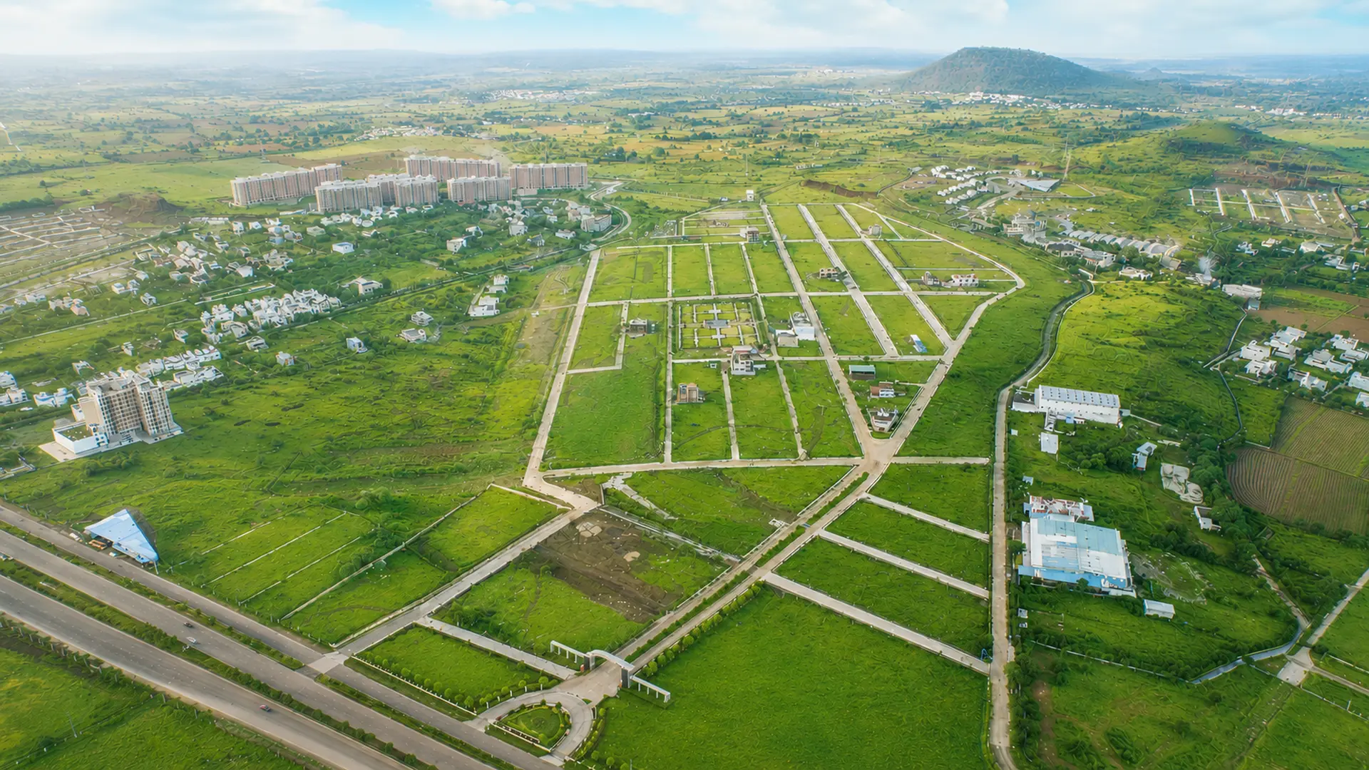Wide aerial overview of the township layout and surrounding green landscape